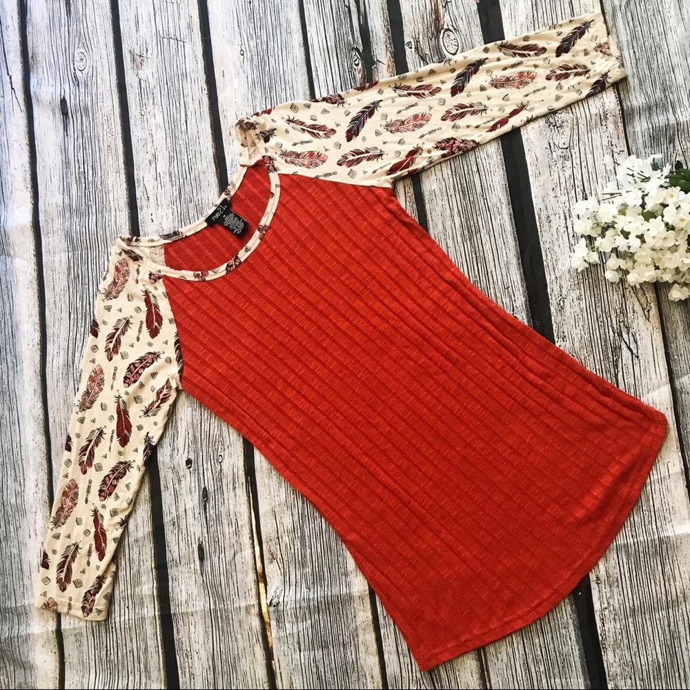 Rue21 knit top with feather printed sleeves.